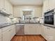 Modern kitchen boasting stainless steel appliances, white cabinets, granite countertops, and tile backsplash at 4132 Sulkirk Rd, Charlotte, NC 28210