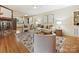 Bright living room with a brick fireplace, modern furniture and decor, and hardwood floors at 4132 Sulkirk Rd, Charlotte, NC 28210