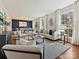Open living room and dining room layout with hardwood floors, large windows, and stylish decor at 4132 Sulkirk Rd, Charlotte, NC 28210