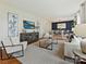 Bright living room featuring hardwood floors, neutral furniture, and an adjacent dining area at 4132 Sulkirk Rd, Charlotte, NC 28210