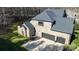 Aerial view of the brick house, 3-car garage and well manicured yard at 4268 Rustling Woods Dr, Denver, NC 28037
