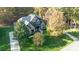 Stunning aerial view of a brick home surrounded by lush trees, with impeccable landscaping and a large private lot at 4268 Rustling Woods Dr, Denver, NC 28037