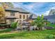 Large backyard with a brick house, patio, and various plants at 4268 Rustling Woods Dr, Denver, NC 28037