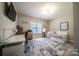Bedroom with desk, daybed, and a large patterned rug at 4268 Rustling Woods Dr, Denver, NC 28037