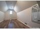 Bonus room featuring vaulted ceilings, wood floors, and a single window for natural light at 4268 Rustling Woods Dr, Denver, NC 28037