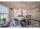 Charming dining room with ample natural light, a decorative rug and a rustic wooden dining table at 4268 Rustling Woods Dr, Denver, NC 28037