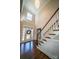 Grand entryway featuring high ceilings, staircase, hardwood floors, and elegant lighting fixture at 4268 Rustling Woods Dr, Denver, NC 28037