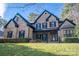 Beautiful brick home featuring a manicured lawn, covered entryway and traditional architectural details at 4268 Rustling Woods Dr, Denver, NC 28037