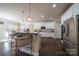 Modern kitchen with stainless steel appliances, pendant lighting, a center island with bar seating and white cabinets at 4268 Rustling Woods Dr, Denver, NC 28037