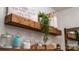 Charming Laundry Room with a rustic shelf decorated with plants and stylish storage jars at 4268 Rustling Woods Dr, Denver, NC 28037