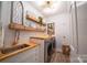 Stylish laundry room with modern appliances, butcher block counters, and decorative shelving at 4268 Rustling Woods Dr, Denver, NC 28037