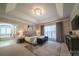 Spacious main bedroom with tray ceiling, plush carpet, king bed, and ensuite access at 4268 Rustling Woods Dr, Denver, NC 28037