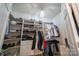 Well-organized walk-in closet with shelving, hanging rods, and ample storage space for clothes and shoes at 4268 Rustling Woods Dr, Denver, NC 28037