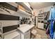 Chic walk-in closet with black and white striped accent wall, vanity area, and custom storage solutions at 4268 Rustling Woods Dr, Denver, NC 28037