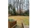 Grassy backyard bordered by a wooden fence and mature trees, offering privacy and space at 4922 Rivergreen Ln, Charlotte, NC 28227