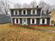 Well-maintained home with gray siding, white shutters, and landscaping at 4922 Rivergreen Ln, Charlotte, NC 28227