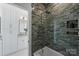 Modern bathroom featuring green tile, a shower and bath, and white cabinets at 5026 Ohm Ln, Charlotte, NC 28270