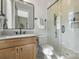 Modern bathroom showcasing a vanity with marble countertop, sleek shower, and updated fixtures at 5026 Ohm Ln, Charlotte, NC 28270