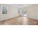 Bedroom with hardwood floors, windows and a private door leading to the back deck at 5026 Ohm Ln, Charlotte, NC 28270