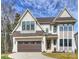 Charming two-story home with a brown roof, a two-car garage and manicured lawn at 5026 Ohm Ln, Charlotte, NC 28270