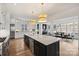 Spacious kitchen with marble island, stainless appliances, breakfast bar, and hardwood floors at 5026 Ohm Ln, Charlotte, NC 28270