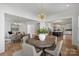 Inviting dining and living spaces with hardwood floors and modern lighting fixtures at 5026 Ohm Ln, Charlotte, NC 28270
