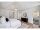Bright main bedroom featuring wood floors, a modern chandelier and ensuite bathroom at 5026 Ohm Ln, Charlotte, NC 28270