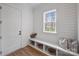 Bright mudroom features shiplap walls, built-in bench with storage, and natural light from a window at 5026 Ohm Ln, Charlotte, NC 28270