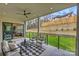 Outdoor living area with comfortable seating, ceiling fan, and scenic backyard views at 5026 Ohm Ln, Charlotte, NC 28270