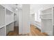 Spacious walk-in closet with custom shelving and wood floors at 5026 Ohm Ln, Charlotte, NC 28270