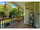 Cozy covered porch area overlooking the lush backyard, offering a peaceful retreat for relaxation and enjoyment at 5051 Oxbow Run Ln, York, SC 29710