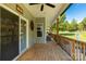 Inviting back porch with wood flooring, ceiling fan, and a view of the backyard at 5051 Oxbow Run Ln, York, SC 29710