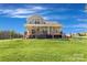 Expansive backyard featuring a wooden deck with comfortable seating and a lush lawn, ideal for outdoor entertainment at 5051 Oxbow Run Ln, York, SC 29710