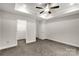 Expansive main bedroom showcasing a tray ceiling, ceiling fan, and a walk-in closet at 5051 Oxbow Run Ln, York, SC 29710