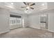 Spacious main bedroom with a tray ceiling, ceiling fan, large window, and an en-suite bathroom at 5051 Oxbow Run Ln, York, SC 29710