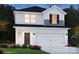 Charming two-story home with a two car garage, white siding and a well-manicured lawn at 5202 Georgette Trl, Cherryville, NC 28021