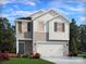 Beautiful two-story home with white and beige siding, a two-car garage and professional landscaping at 5204 Georgette Trl, Cherryville, NC 28021