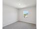 Bedroom featuring neutral walls, plush carpet, and a window overlooking the neighborhood at 5207 Georgette Trl, Cherryville, NC 28021