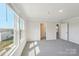 Bright bedroom featuring neutral walls, plush carpet, and natural light from the large window at 5207 Georgette Trl, Cherryville, NC 28021