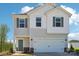 Charming two-story home featuring a white garage door, teal front door, and complementary window shutters at 5207 Georgette Trl, Cherryville, NC 28021