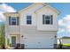 Charming two-story home featuring a white garage door, teal front door, and complementary window shutters at 5207 Georgette Trl, Cherryville, NC 28021