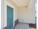 A beautiful teal front door with brick foundation and white pillars at 5207 Georgette Trl, Cherryville, NC 28021