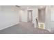 Upstairs hallway featuring neutral walls, plush carpet, and natural light from the stairwell window at 5207 Georgette Trl, Cherryville, NC 28021