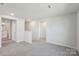 Hallway featuring neutral walls and plush carpet leading to a bathroom and additional living space at 5207 Georgette Trl, Cherryville, NC 28021
