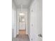 Hallway view showcasing a full bathroom featuring tile floors, a mirror, and bright neutral paint at 5207 Georgette Trl, Cherryville, NC 28021