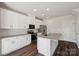 Clean kitchen with white cabinets, stainless steel appliances, and granite countertops at 5207 Georgette Trl, Cherryville, NC 28021