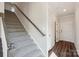 Carpeted stairs with wooden handrail, providing access to the home's upper level at 5207 Georgette Trl, Cherryville, NC 28021
