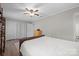 Bedroom featuring a ceiling fan, closet, wood-look floors, and neutral colored walls at 623 S New Hope Rd # 4, Gastonia, NC 28054