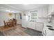 Open kitchen area with white cabinets and access to the dining space at 623 S New Hope Rd # 4, Gastonia, NC 28054