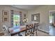 Stylish dining room with natural light, a large wood table, and seating for six people at 7718 Woolsey Dr, Gastonia, NC 28056